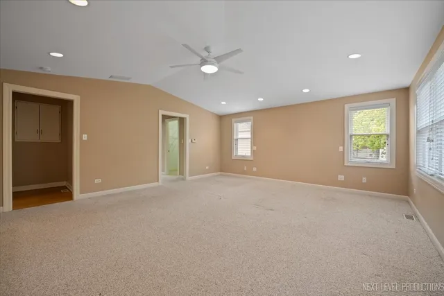 an empty room with windows and closet