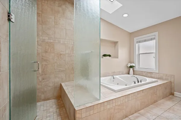 a bathroom with a bathtub and shower