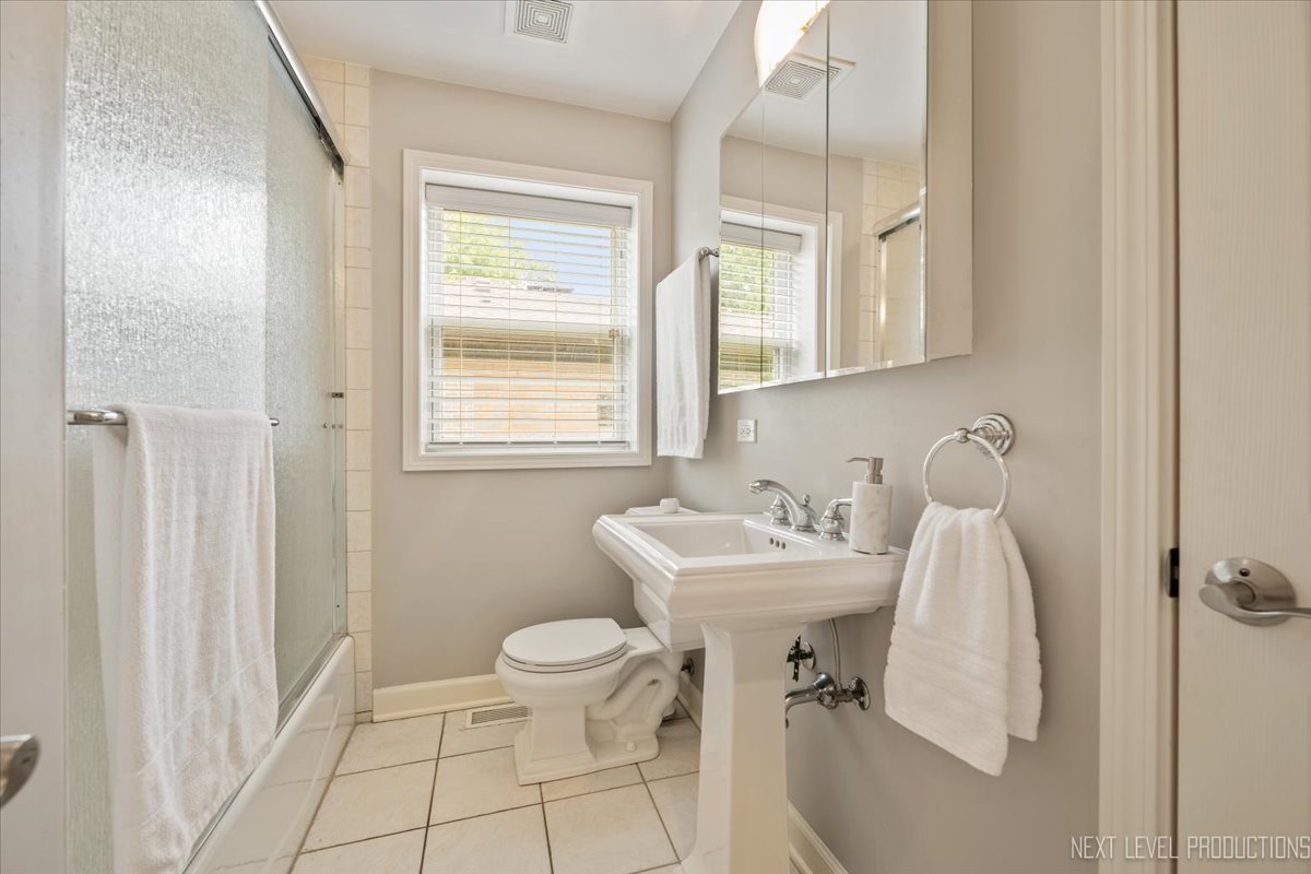 4830 Wolf Road Western Springs, IL 60558 - Photo 29 of 46 a bathroom with a sink toilet and a mirror