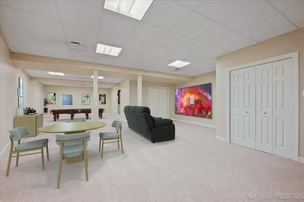 a living room with furniture and a gym machine