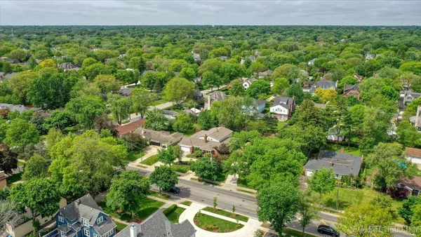 an aerial view of a house with garden space and street view