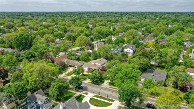 an aerial view of a house with garden space and street view