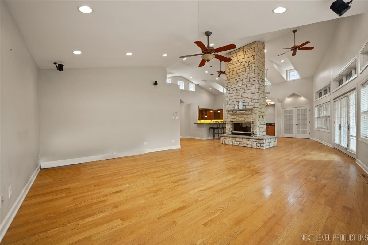 4830 Wolf Road Western Springs, IL 60558 - Photo 9 of 46 a big room with wooden floor a ceiling fan and windows