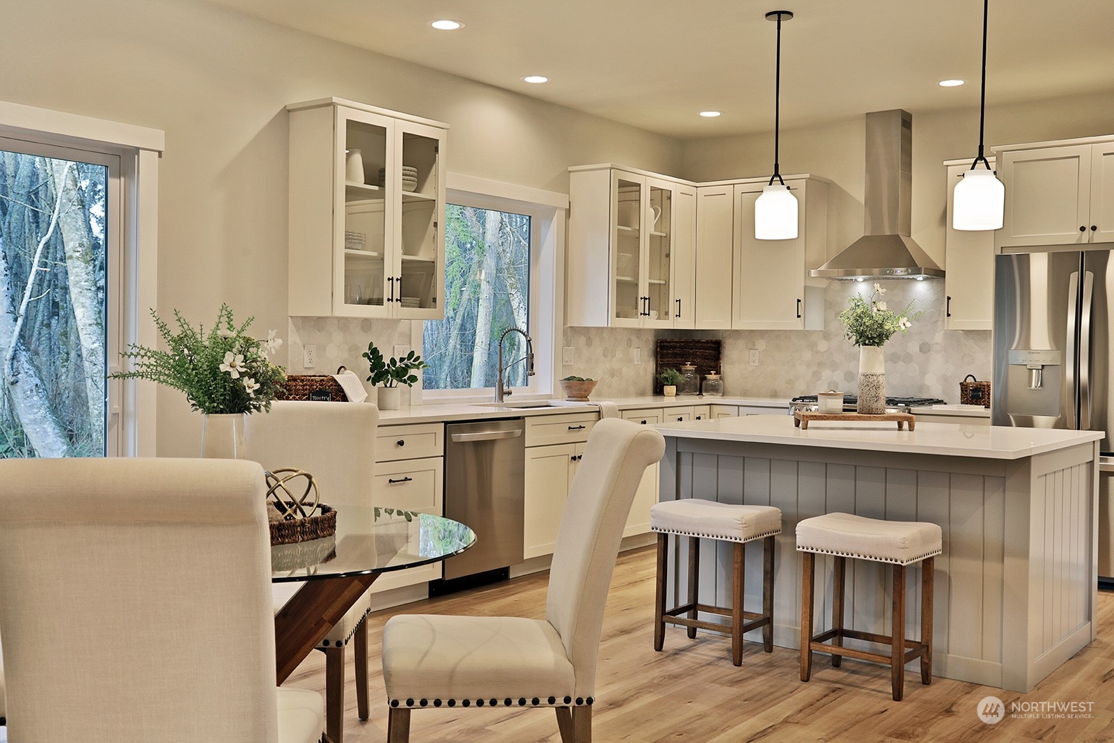 1831 Watkins Road Freeland, WA 98249 - Photo 11 of 37 a kitchen with a table chairs refrigerator and microwave
