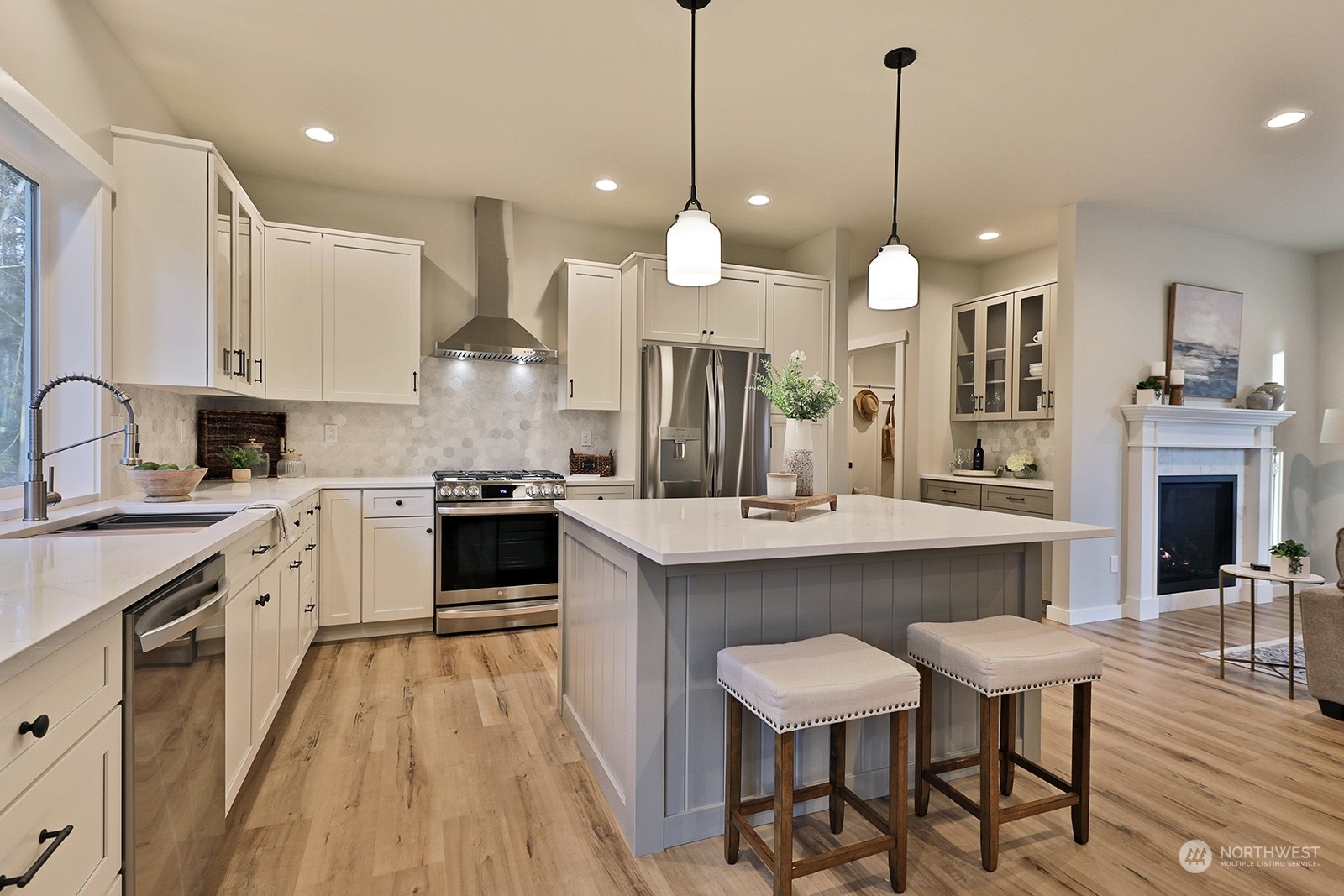 1831 Watkins Road Freeland, WA 98249 - Photo 13 of 37 a kitchen with kitchen island a dining table chairs sink and stove
