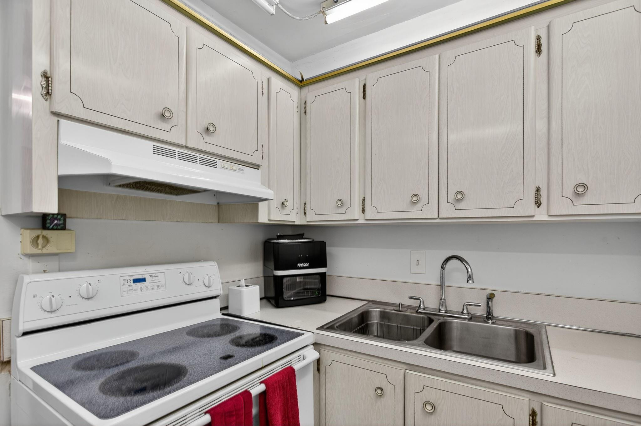 418 South Cypress Road, Unit 110 Pompano Beach, FL 33060 - Photo 11 of 28 a kitchen with a sink and cabinets