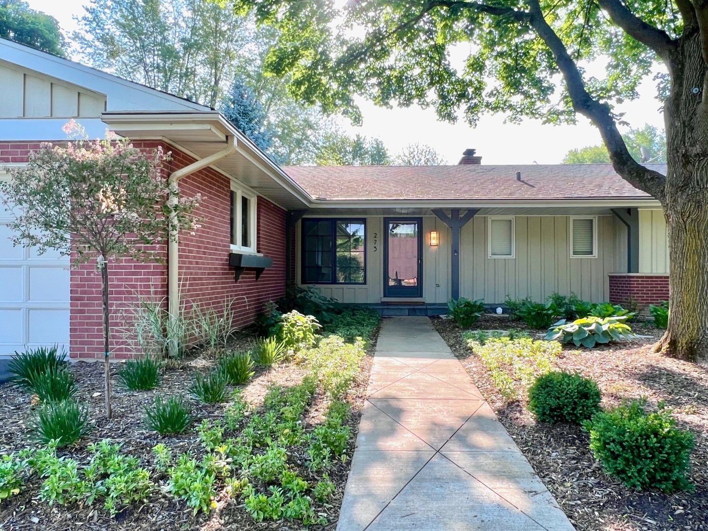275 Cold Spring Road Barrington, IL 60010 - Photo 2 of 33 a front view of a house with a yard and potted plants