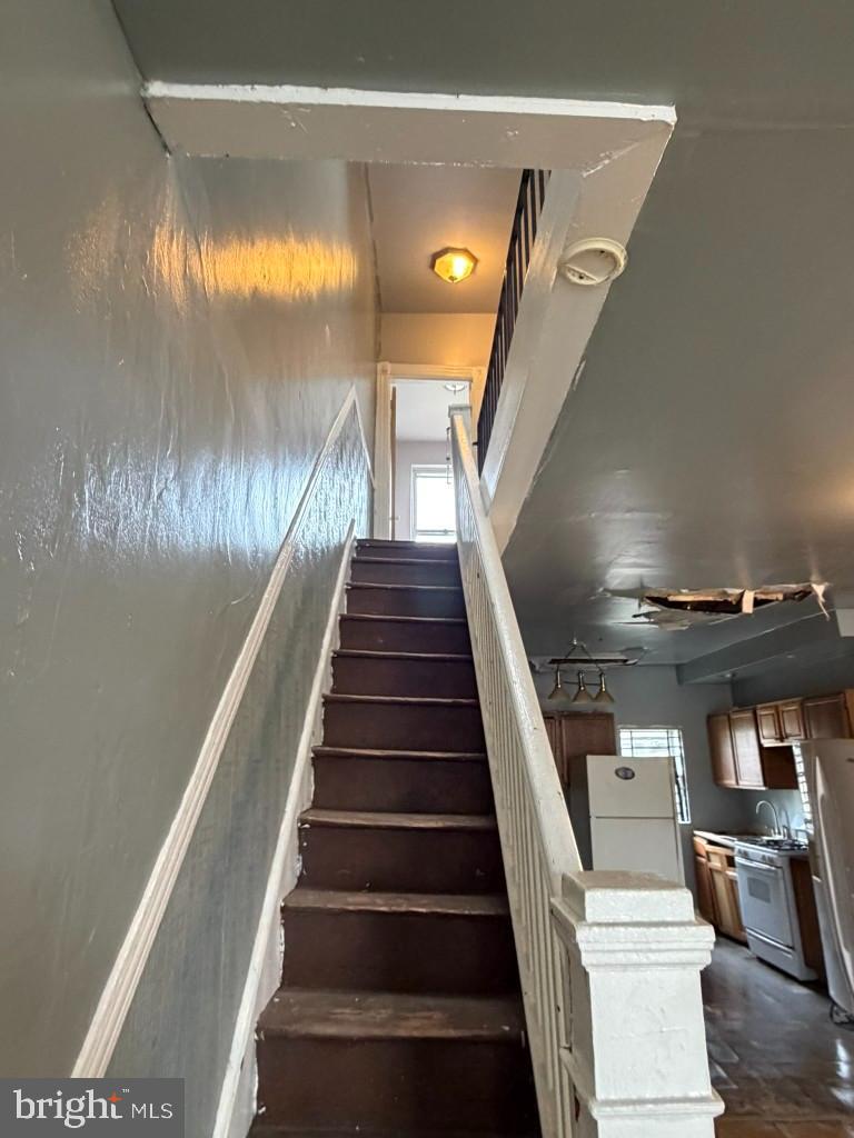 1827 North Milton Avenue Baltimore, MD 21213 - Photo 14 of 49 a view of entryway and hall with wooden floor