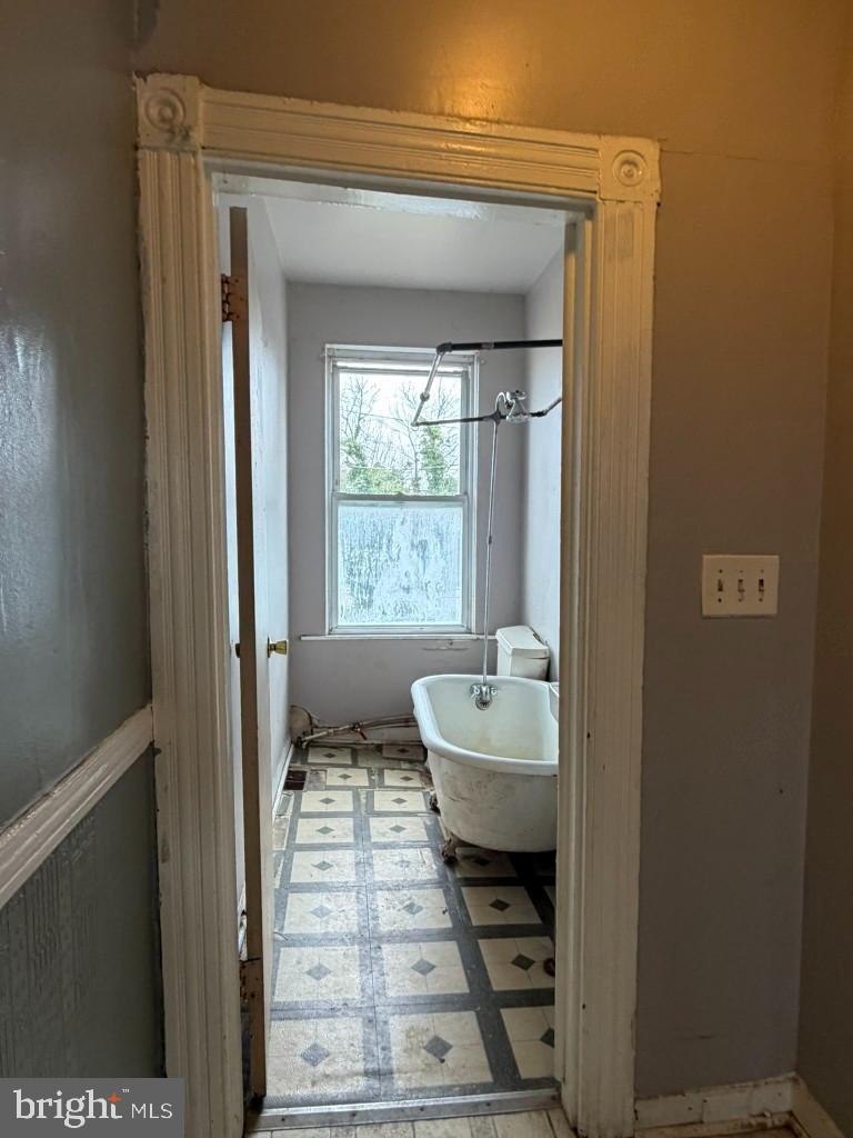 1827 North Milton Avenue Baltimore, MD 21213 - Photo 31 of 49 a bathroom with a toilet a sink and window