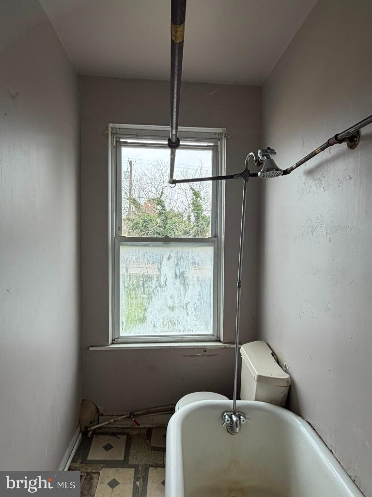 1827 North Milton Avenue Baltimore, MD 21213 - Photo 32 of 49 a bathroom with a bathtub and a window