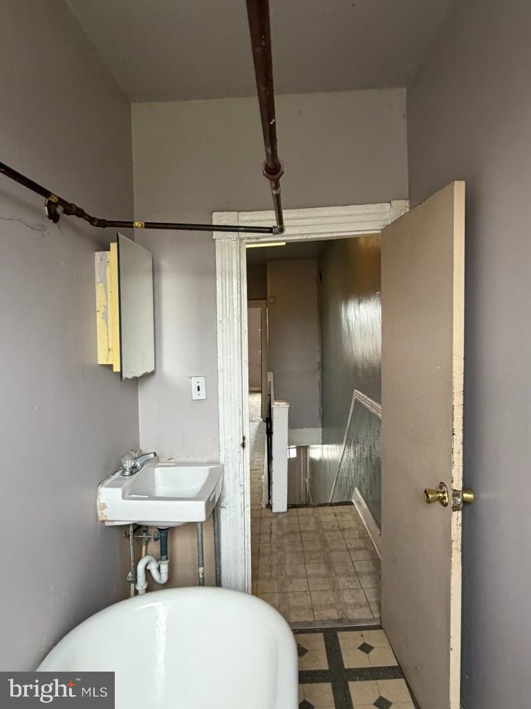 1827 North Milton Avenue Baltimore, MD 21213 - Photo 33 of 49 a bathroom with a sink and a mirror