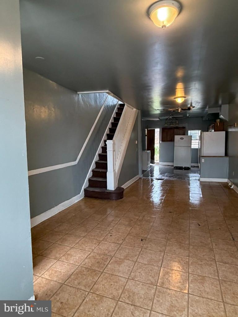 1827 North Milton Avenue Baltimore, MD 21213 - Photo 7 of 49 a view of an empty room with wooden floor