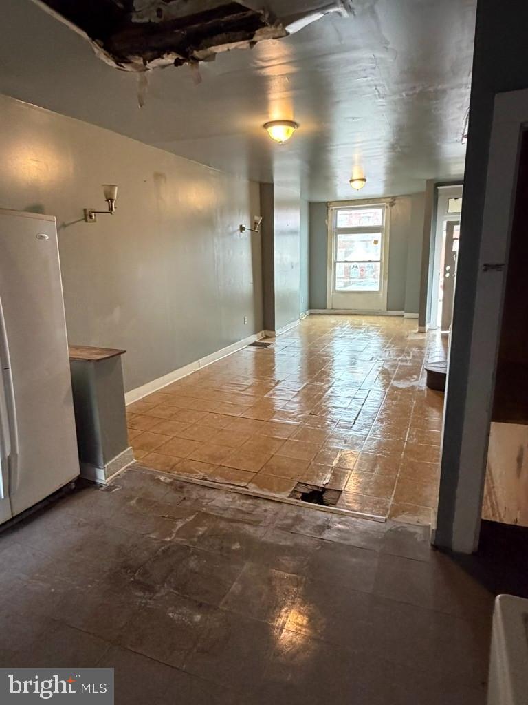 1827 North Milton Avenue Baltimore, MD 21213 - Photo 10 of 49 a view of empty room with wooden floor and fan