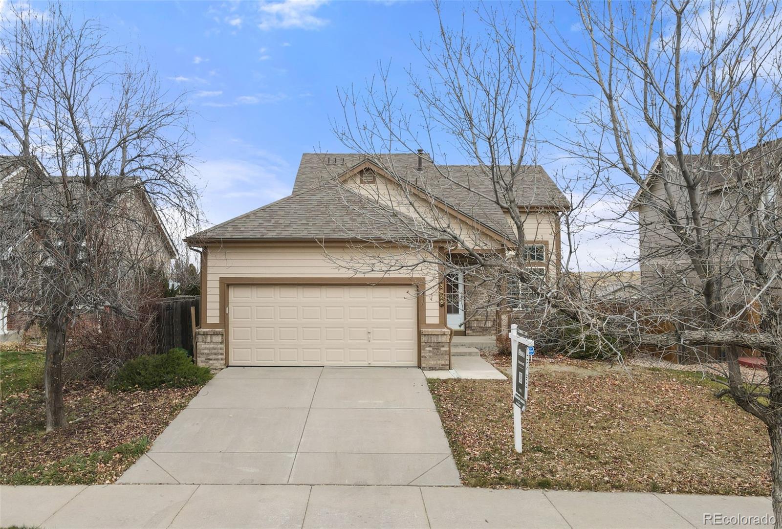 3828 South Rome Way Aurora, CO 80018 - Photo 19 of 19 a front view of a house with a yard and garage