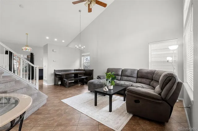 a living room with furniture and a dining table with kitchen view