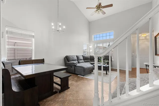 a living room with furniture a chandelier and a window