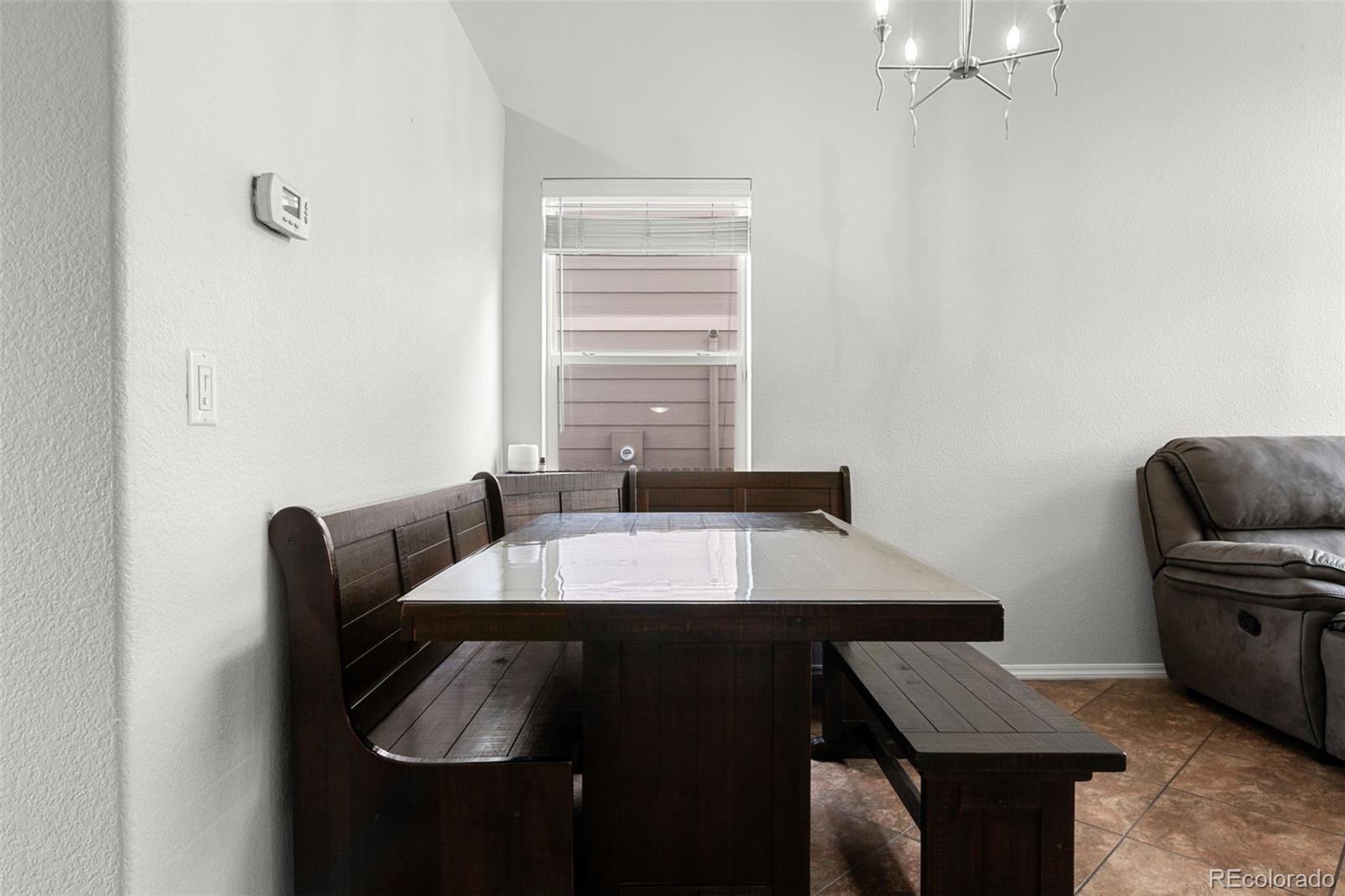 3828 South Rome Way Aurora, CO 80018 - Photo 6 of 19 a room with furniture and window