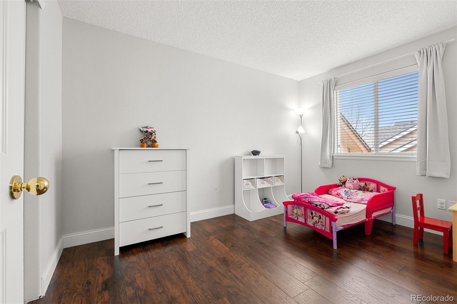 3828 South Rome Way Aurora, CO 80018 - Photo 8 of 19 a bedroom with a bed and a window