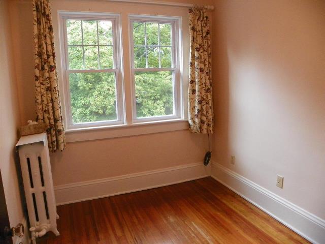 2107 Carter Road Southwest Roanoke, VA 24015 - Photo 16 of 18 a view of an empty room with wooden floor and a window