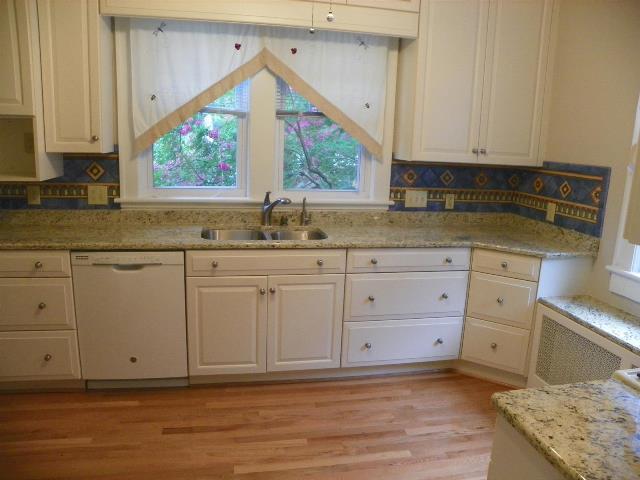 2107 Carter Road Southwest Roanoke, VA 24015 - Photo 4 of 18 a kitchen with granite countertop white cabinets and a window