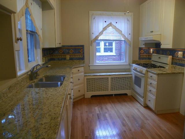 2107 Carter Road Southwest Roanoke, VA 24015 - Photo 5 of 18 a kitchen with a cabinets a sink and wooden floor