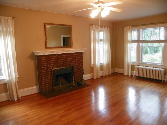 2107 Carter Road Southwest Roanoke, VA 24015 - Photo 9 of 18 wooden floor fireplace and windows in an empty room