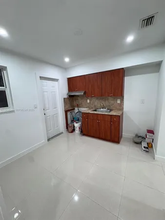 an empty room with furniture and storage