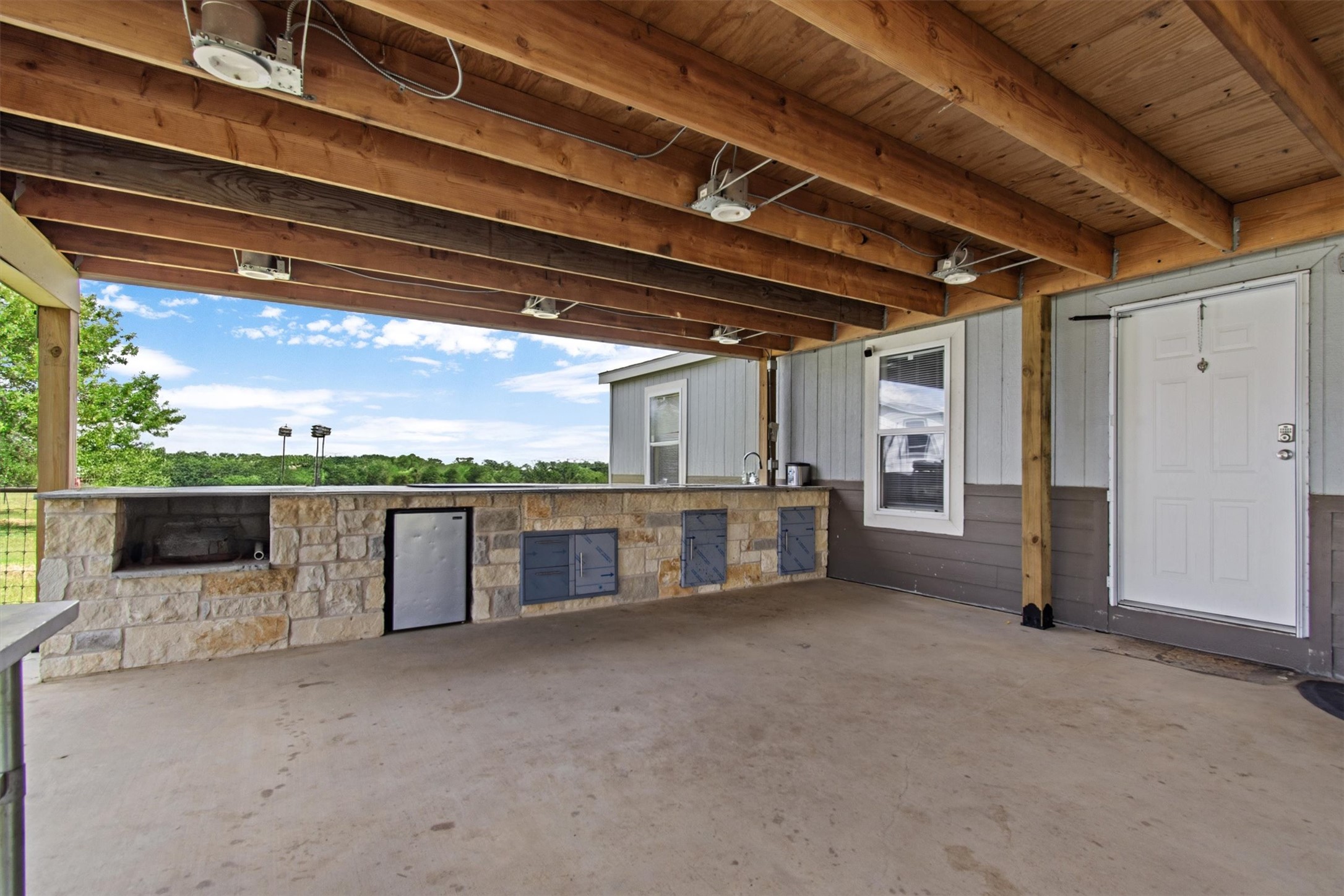480 Grandpa Road Lockhart, TX 78644 - Photo 21 of 35 The centerpiece is a spacious ~2,061 sq ft manufactured home, just 1.5
years old, with 4 bedrooms, 2 bathrooms, and a beautifully crafted 40' x 20' stone outdoor kitchen under a covered
roof with lighting—ideal for hosting under the stars.