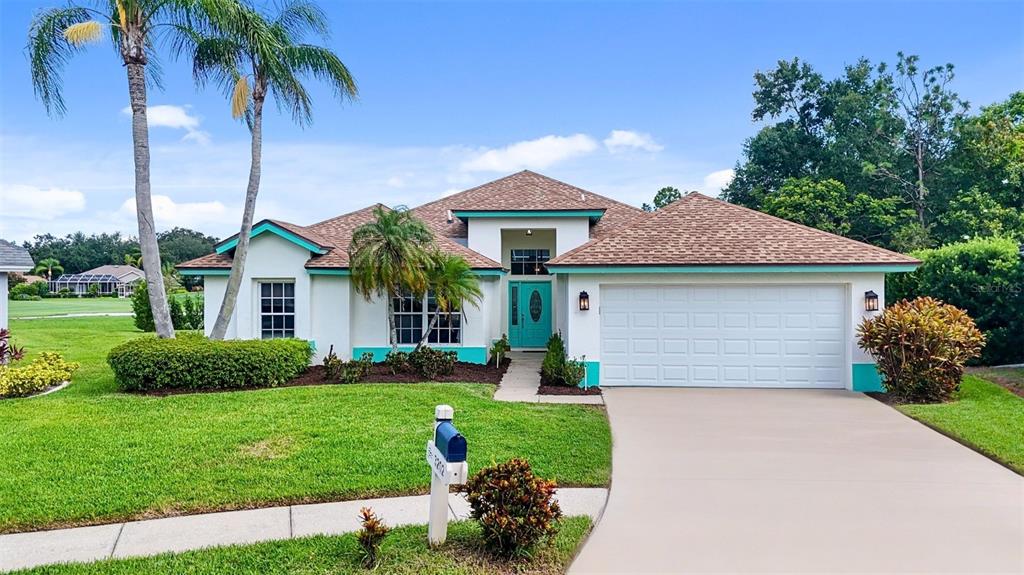 3202 Fox Squirrel Lane Valrico, FL 33596 - Photo 1 of 48 a front view of a house with a yard and garage