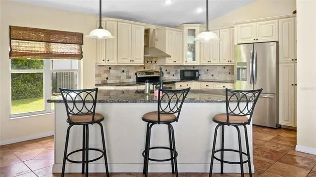 a view of a kitchen with appliances and dining table