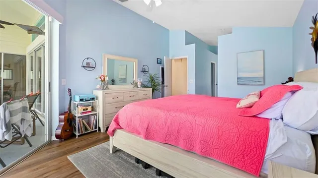 a bedroom with a bed and a large mirror on the dresser