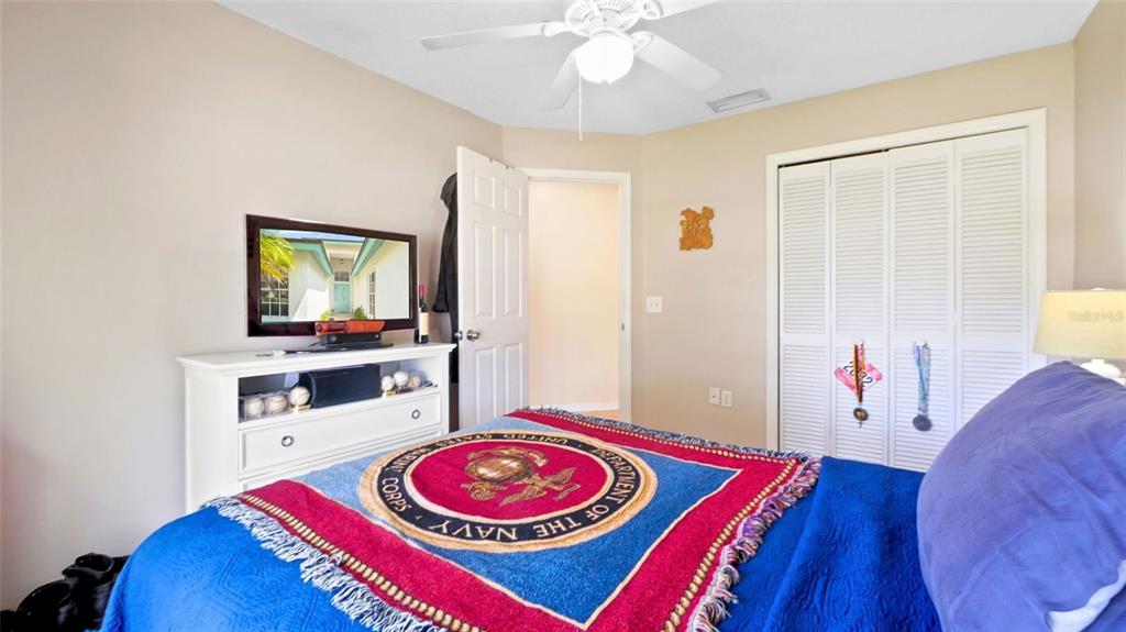 3202 Fox Squirrel Lane Valrico, FL 33596 - Photo 20 of 48 a living room with a bed and a flat screen tv