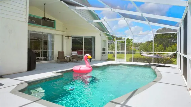 a view of a backyard with table and chairs and potted plants