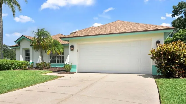 a view of a house with a yard and potted plants