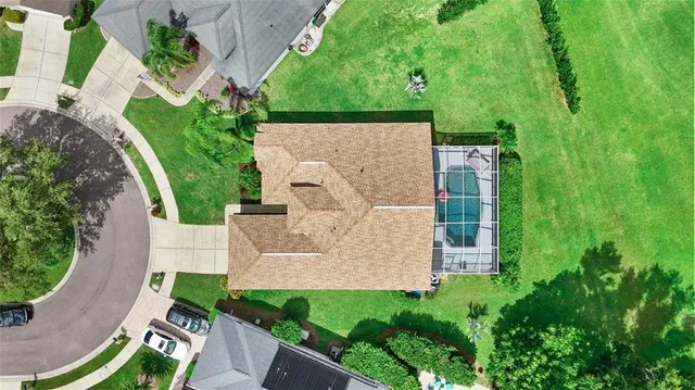an aerial view of a house with garden space and street view