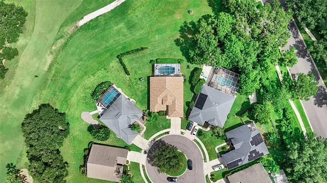 an aerial view of a house with garden space and street view