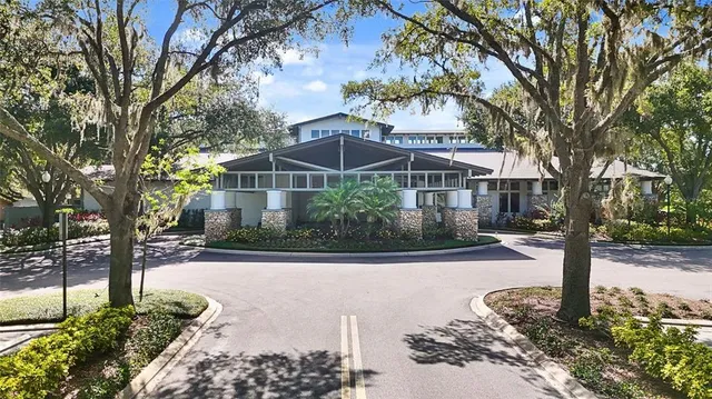a front view of a house with trees and snow