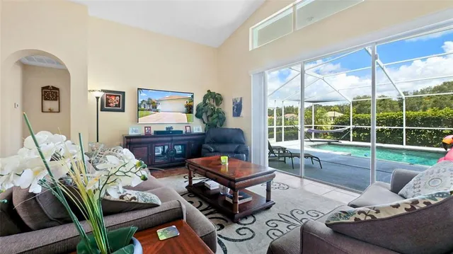 a living room with furniture and a floor to ceiling window