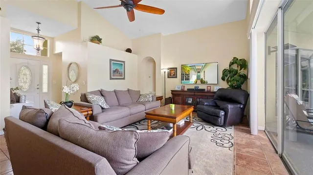 a living room with furniture ceiling fan and a rug