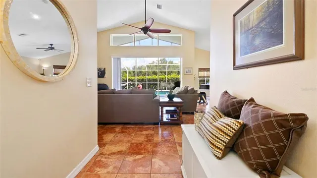 a living room with furniture a large window and a chandelier