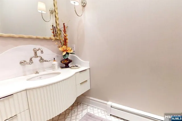 a view of a hallway with a dining table and chairs