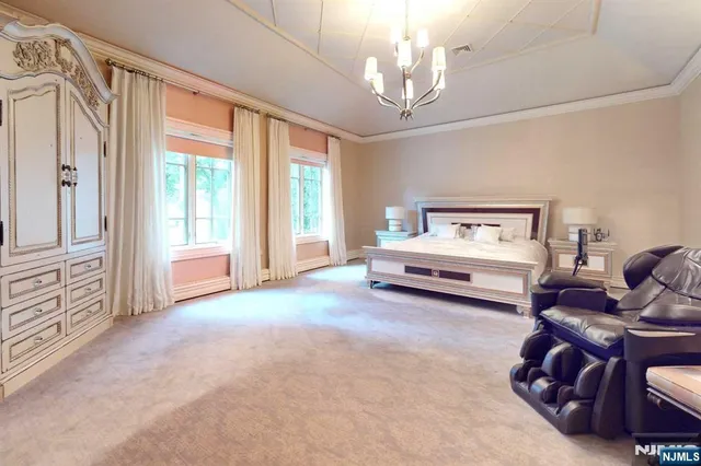 a spacious bathroom with double vanity a large mirror a bathtub and a sink