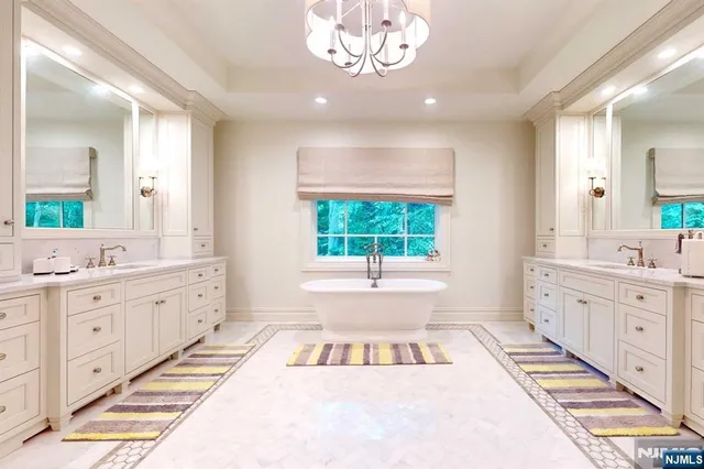 a large white kitchen with a large tub and sink