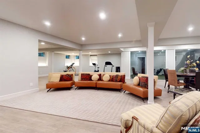 a room with gym equipment and wooden floor