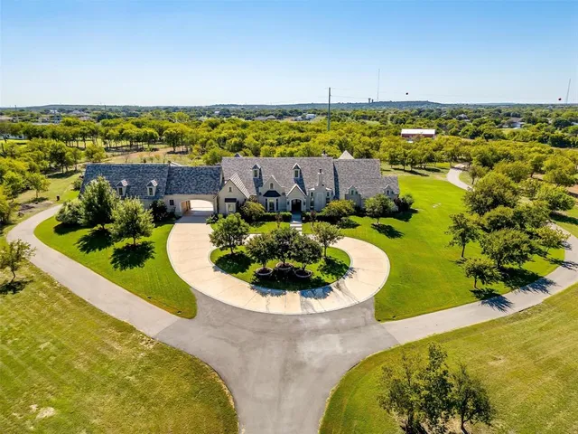 a view of a swimming pool with a lawn chairs and floor to ceiling window