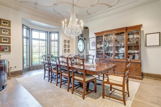 a view of a dining room with furniture a chandelier and wooden floor