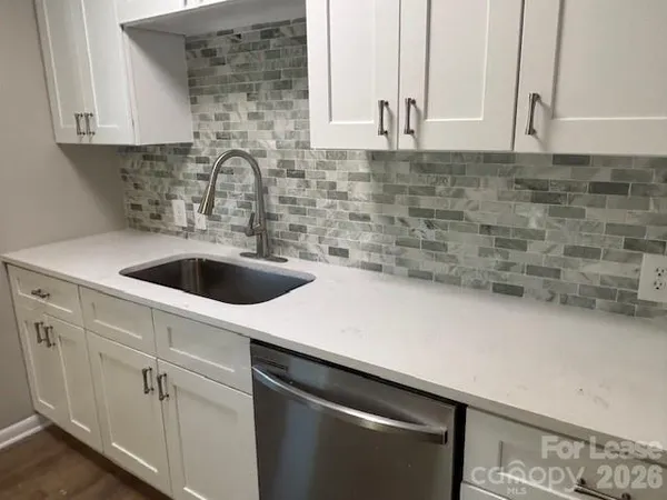 a kitchen with stainless steel appliances a sink a stove and cabinets