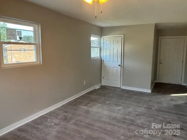 an empty room with windows and closet