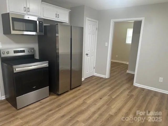 a kitchen with a refrigerator stove and microwave