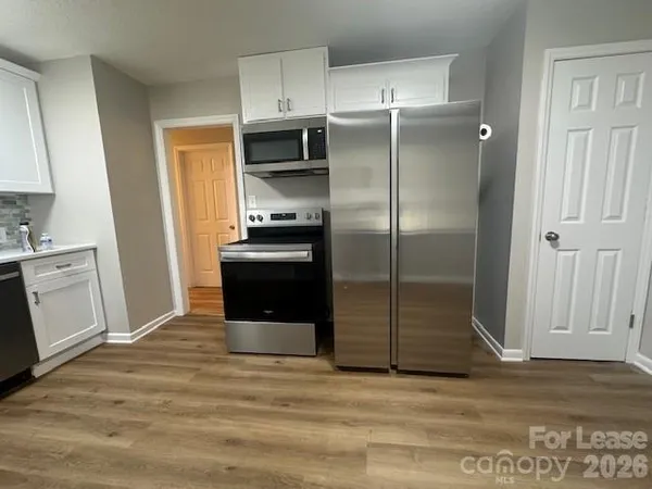 a kitchen with a refrigerator and a sink